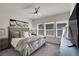Comfortable bedroom with large windows, ceiling fan, and modern decor, perfect for restful nights at 4625 Ridgeley Ave # 102, North Las Vegas, NV 89084