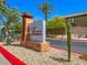 Beautifully landscaped community entrance sign with desert plants and vibrant red accents at 4625 Ridgeley Ave # 102, North Las Vegas, NV 89084