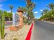 Inviting community entrance with decorative signage, lush greenery, and a well-maintained roadway at 4625 Ridgeley Ave # 102, North Las Vegas, NV 89084