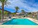 Sparkling community pool with lounge chairs, surrounded by well-maintained landscaping and palm trees at 4625 Ridgeley Ave # 102, North Las Vegas, NV 89084