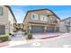 View of a two story townhome with a private balcony and attached garages at 4625 Ridgeley Ave # 102, North Las Vegas, NV 89084