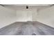 Spacious garage with concrete flooring, white walls, and an access door to the home's interior at 4625 Ridgeley Ave # 102, North Las Vegas, NV 89084