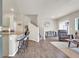 Open-concept living room featuring hardwood floors, stairs and lots of natural light at 4625 Ridgeley Ave # 102, North Las Vegas, NV 89084
