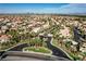 Expansive aerial view of a well-planned community featuring palm-lined streets and diverse homes at 4651 Munich Ct, Las Vegas, NV 89147
