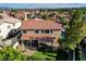Aerial view showcasing a beautifully maintained home with a lush green lawn and mature trees at 4651 Munich Ct, Las Vegas, NV 89147