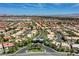 Vast aerial view of a community entrance lined with palm trees and manicured landscaping at 4651 Munich Ct, Las Vegas, NV 89147