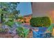 Backyard seating area with colorful Adirondack chairs and a fire pit for relaxing evenings outdoors at 4651 Munich Ct, Las Vegas, NV 89147
