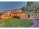 Expansive backyard features a large lawn, covered patio with string lights, and mature landscaping, offering a serene outdoor space at 4651 Munich Ct, Las Vegas, NV 89147