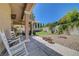 Inviting backyard oasis featuring a covered patio, lush lawn, and landscaped garden at 4651 Munich Ct, Las Vegas, NV 89147