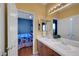 Well-lit en-suite bathroom features double sinks, neutral cabinets, and adjacent bedroom at 4651 Munich Ct, Las Vegas, NV 89147