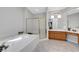 Luxurious bathroom with a soaking tub, glass shower, and oak cabinets at 4651 Munich Ct, Las Vegas, NV 89147