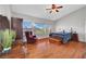 Spacious bedroom features wood floors, a ceiling fan, and large window for natural light at 4651 Munich Ct, Las Vegas, NV 89147