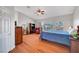 Bright bedroom features a ceiling fan, wood floors, a large window, and ample space at 4651 Munich Ct, Las Vegas, NV 89147