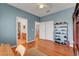 Bedroom with hardwood floors, closet, and access to bathroom and hallway at 4651 Munich Ct, Las Vegas, NV 89147