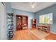 Bright bedroom with hardwood floors, large bookshelves, and a desk area for studying at 4651 Munich Ct, Las Vegas, NV 89147