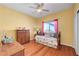 Comfortable bedroom with floral bedding, dresser, and hardwood floors at 4651 Munich Ct, Las Vegas, NV 89147