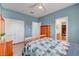 Cozy bedroom with blue walls, hardwood floors, closet, and a door to the en-suite bathroom at 4651 Munich Ct, Las Vegas, NV 89147