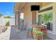 Charming covered patio featuring a cozy seating area and outdoor dining at 4651 Munich Ct, Las Vegas, NV 89147