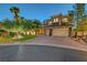 Beautiful two-story home with a well-manicured lawn, a brick driveway, and a three-car garage at 4651 Munich Ct, Las Vegas, NV 89147