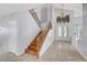 Grand foyer with high ceilings, wood staircase, and large windows letting in plenty of natural light at 4651 Munich Ct, Las Vegas, NV 89147