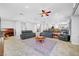 Expansive living room with comfortable leather seating and view of dining area and kitchen at 4651 Munich Ct, Las Vegas, NV 89147