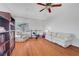 Bright living room with hardwood floors, ceiling fan, and comfortable seating perfect for relaxing or entertaining at 4651 Munich Ct, Las Vegas, NV 89147