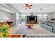 Spacious living room with ceiling fan, tile floors, and entertainment center at 4651 Munich Ct, Las Vegas, NV 89147