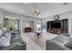 Comfortable living room with leather seating, ceiling fan, and tile flooring at 4651 Munich Ct, Las Vegas, NV 89147