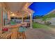 Backyard patio with comfortable seating, a barrel table, and string lights for outdoor entertaining at 4651 Munich Ct, Las Vegas, NV 89147