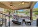 Inviting outdoor seating area under a covered patio with fans, string lights, and a lush green lawn at 4651 Munich Ct, Las Vegas, NV 89147