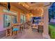 Inviting covered patio featuring a bar, grill, ceiling fans, and string lights, creating an ideal space for entertaining at 4651 Munich Ct, Las Vegas, NV 89147