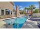 Beautiful backyard pool with lush landscaping and a relaxing spa area at 4651 Munich Ct, Las Vegas, NV 89147