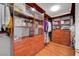 Large walk-in closet with custom wood shelving and drawers for ample storage at 4651 Munich Ct, Las Vegas, NV 89147