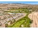 A scenic view of the community with lush golf course, ponds, and mountains in the distance at 4820 Se Clifftop Dr, Pahrump, NV 89061