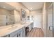 Bright bathroom featuring double sinks, ample counter space, and a glass-enclosed shower at 4820 Se Clifftop Dr, Pahrump, NV 89061