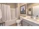 Bathroom featuring a shower-tub combo, gray vanity, and neutral paint at 4820 Se Clifftop Dr, Pahrump, NV 89061