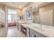 Bright bathroom featuring double sinks, plenty of counter space, a walk-in shower, and access to the bedroom at 4820 Se Clifftop Dr, Pahrump, NV 89061