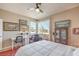 Bedroom with a ceiling fan, natural light, desk, and red rug at 4820 Se Clifftop Dr, Pahrump, NV 89061