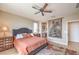 Inviting bedroom with a ceiling fan, soft lighting, and ensuite bathroom at 4820 Se Clifftop Dr, Pahrump, NV 89061