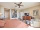 Cozy bedroom with a ceiling fan, dresser, TV, and an ensuite bathroom at 4820 Se Clifftop Dr, Pahrump, NV 89061