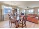 Bright dining space in an open layout, featuring hardwood floors and a view of the adjacent living room at 4820 Se Clifftop Dr, Pahrump, NV 89061