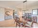 Formal dining room with natural light, hardwood floors, dark wood cabinet, and space for Gathering gatherings at 4820 Se Clifftop Dr, Pahrump, NV 89061