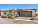 Charming single-story home featuring a brick driveway, well-maintained landscaping, and an attached two-car garage at 4820 Se Clifftop Dr, Pahrump, NV 89061