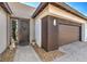 Welcoming front entryway with charming décor, a two-car garage and a well-maintained pathway at 4820 Se Clifftop Dr, Pahrump, NV 89061