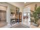 Hallway featuring neutral walls, light flooring, and opening into the living room and bathroom at 4820 Se Clifftop Dr, Pahrump, NV 89061