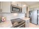 Well-equipped kitchen with stainless steel appliances, white cabinetry, and subway tile backsplash at 4820 Se Clifftop Dr, Pahrump, NV 89061