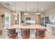 Modern kitchen with a large center island, pendant lighting, and stainless steel appliances at 4820 Se Clifftop Dr, Pahrump, NV 89061