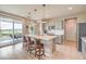 Open kitchen featuring a large island with bar seating, pendant lighting, and sliding glass doors leading to an outdoor patio at 4820 Se Clifftop Dr, Pahrump, NV 89061