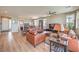Spacious living room boasts hardwood floors, neutral walls, ceiling fan, and a cozy seating arrangement at 4820 Se Clifftop Dr, Pahrump, NV 89061
