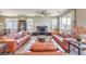 Spacious living room featuring leather sofas, neutral walls, and a ceiling fan for a comfortable and inviting atmosphere at 4820 Se Clifftop Dr, Pahrump, NV 89061
